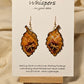 Golden Dragonfly Leaf Hand Painted Paper Earrings. Ultra light weight. 2" Leaf shape. Painted in rust and muted red tones with Golden paper dragonfly atop. Outlined in Dark brown. Back is painted in similar design. 14kg over Sterling Silver ear wires and findings. Resin coating for durability. Hangs 2"