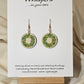 Holiday Wreath Hand Painted Wood Earrings. 1" Stained wood round, two toned Holiday wreath painted with white and colored berries. Ultra light weight. Back of earring is stained natural. Enameled for durability. 14kg over sterling ear wires and findings. Hangs 1 1/4"
