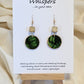 Leaf Relief Hand Crafted Wood Earrings. 1" Wood Disc with two tone green handmade paper painted gold edges and hanging from cream colored square wooden bead. Resin Coating for durability. Back is done to compliment. 14kg over sterling ear wire sterling silver findings. Hangs 1 3/4"