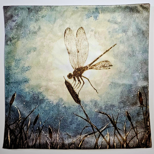 Artistic Silhouette depiction of a dragonfly landing on a cat tail in the moonlight 