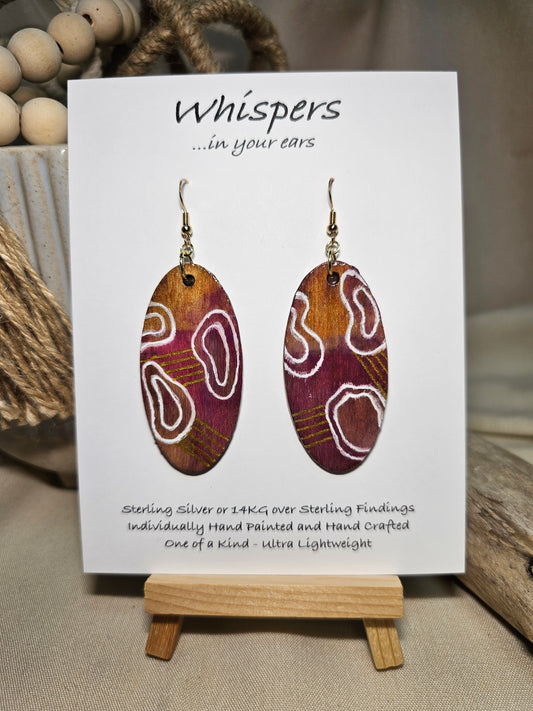 Organic Boho Hand Painted Wood Earrings. Organic shapes and metallic lines painted in acrylics. Back is painted in similar color. Ultra light weight. Resin coating for durability. 2" Elongated wood oval. 14kg over Sterling silver mixed metals with sterling silver findings and hangs 2 1/4" in length