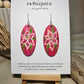 Pink Lily Bloom Hand Painted Wood Earrings. Lily floral bloom, painted in acrylics. Back is painted in similar color. Ultra light weight. Enameled for durability. 2" Elongated wood oval. Sterling silver mixed metals with sterling silver findings and hangs 2 1/4" in length