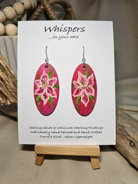 Pink Lily Bloom Hand Painted Wood Earrings. Lily floral bloom, painted in acrylics. Back is painted in similar color. Ultra light weight. Enameled for durability. 2" Elongated wood oval. Sterling silver mixed metals with sterling silver findings and hangs 2 1/4" in length