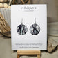 Roots Nature Inspired Hand Painted Paper Earrings. Ultra lightweight 1 1/4" Circle. Black washed roots a top a blue grey washed background. Back is painted in complimentary colors and design. Resin coating for durability. Sterling silver ear wires and findings. Hangs 1 1/2" length