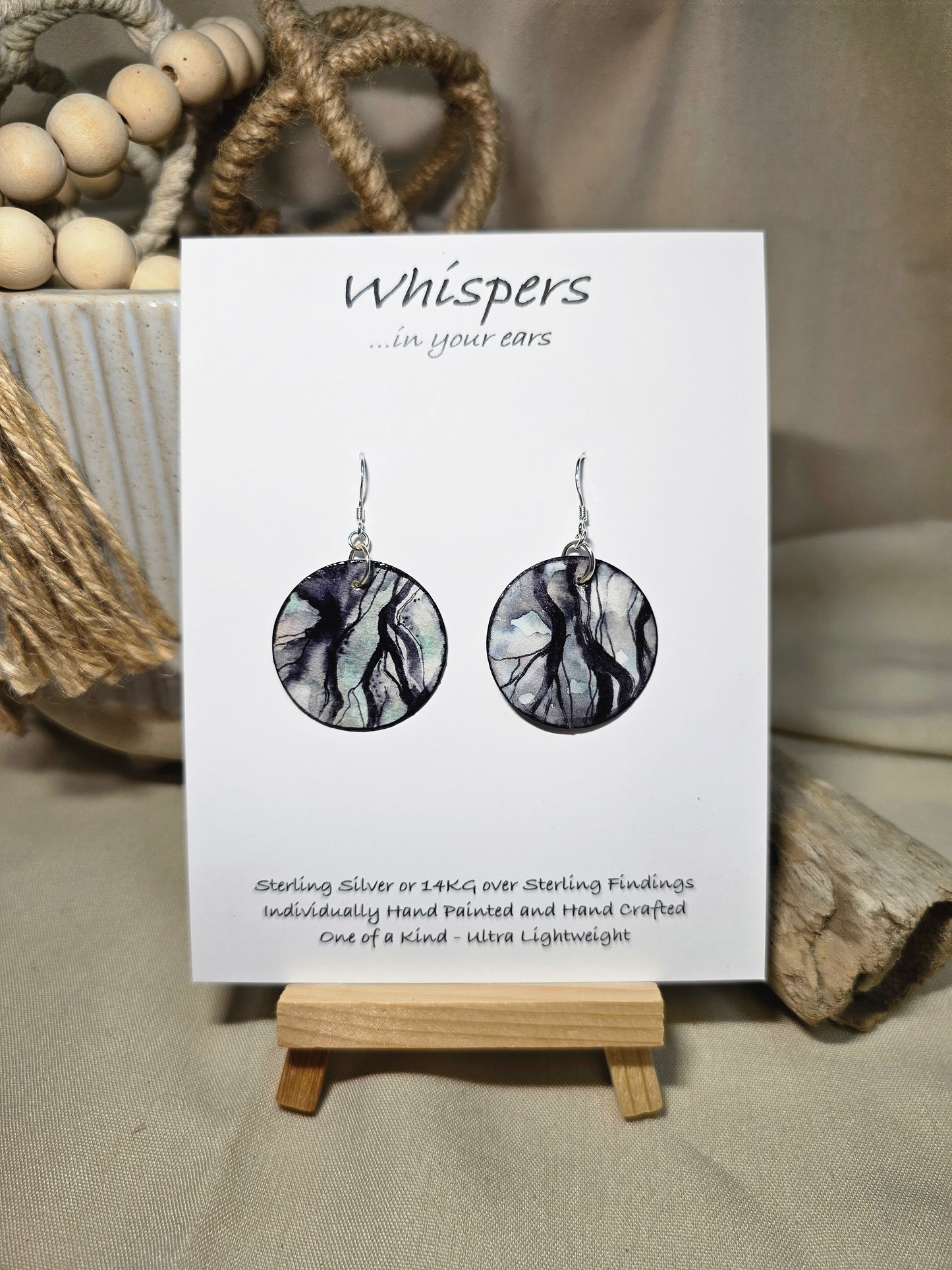 Roots Nature Inspired Hand Painted Paper Earrings. Ultra lightweight 1 1/4" Circle. Black washed roots a top a blue grey washed background. Back is painted in complimentary colors and design. Resin coating for durability. Sterling silver ear wires and findings. Hangs 1 1/2" length