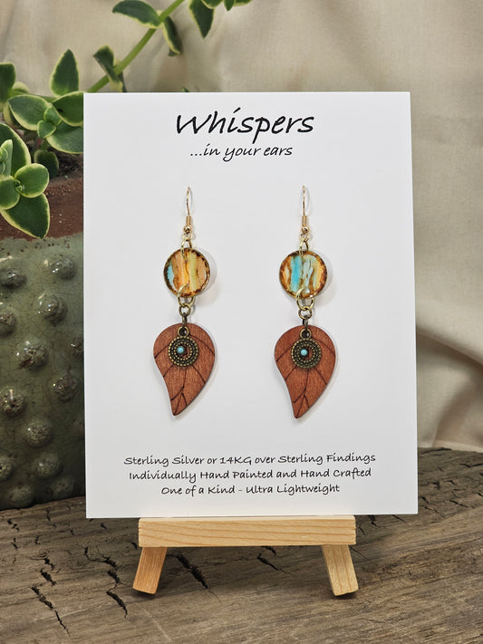 Rustic Leaf Hand Painted Paper Earrings with Wood leaf Pendant. 1/2" Circular artisan paper aqua blue, peach and light brown organic linear pattern with brown painted edges. Resin Coating for durability. Back is done to compliment. 14kg over Sterling silver findings. Hangs 2 1/4"