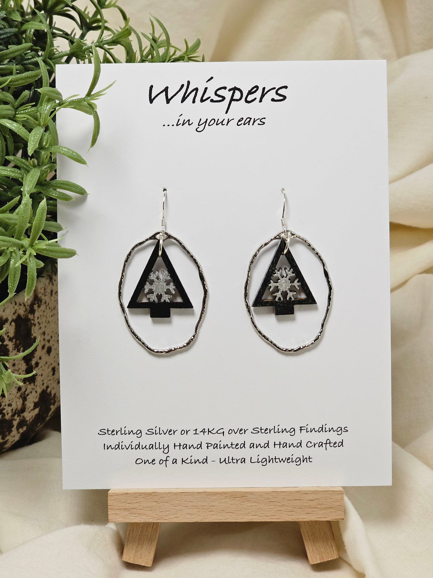 Snowflake Tree Hand painted/Crafted Wood Earrings. Christmas Tree die cut painted in black and silver. Dangling in a light weight silver alloy frame. Back is exactly the same. Enameled for durability. Sterling Silver ear wires and findings. Hangs 1 1/2"