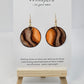 Wooden Glow Hand painted Paper earrings. Look of wood in bark pattern, orange glow and brown and dark brown lines. Gold metallic veining. Back of earring is painted to match. Ultra lightweight. Resin coated for durability. 1 1/2" diameter. 14KG over Sterling findings. Hangs 1 3/4" in length