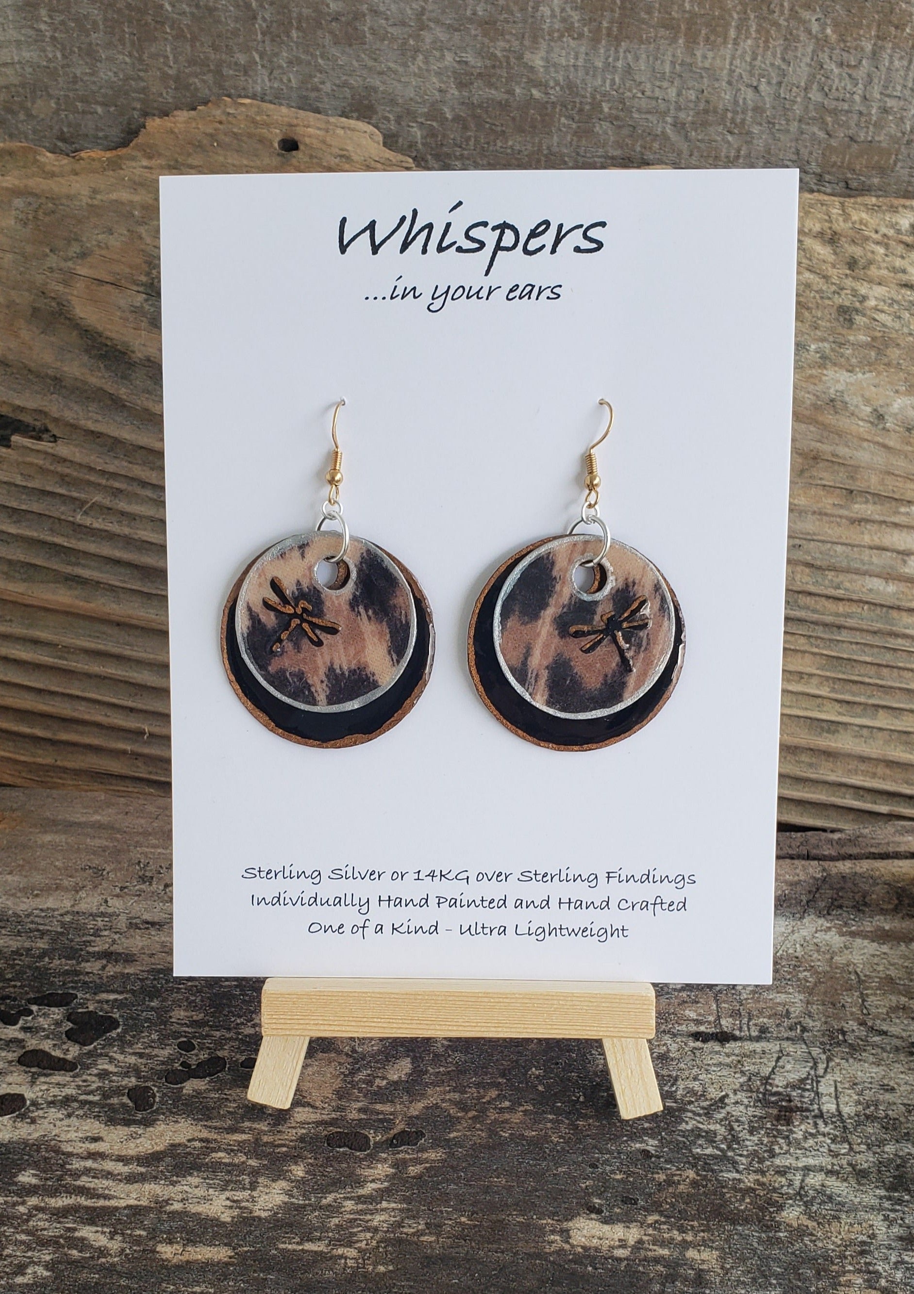 Hand painted ultra lightweight paper earrings. 3D Dragonfly accented cheetah print. Double layer gold and silver painted edge accents.  Back is painted black.  Circular in shape. Sterling Silver and 14kg over silver findings.  Hangs 1 1/2" in Length