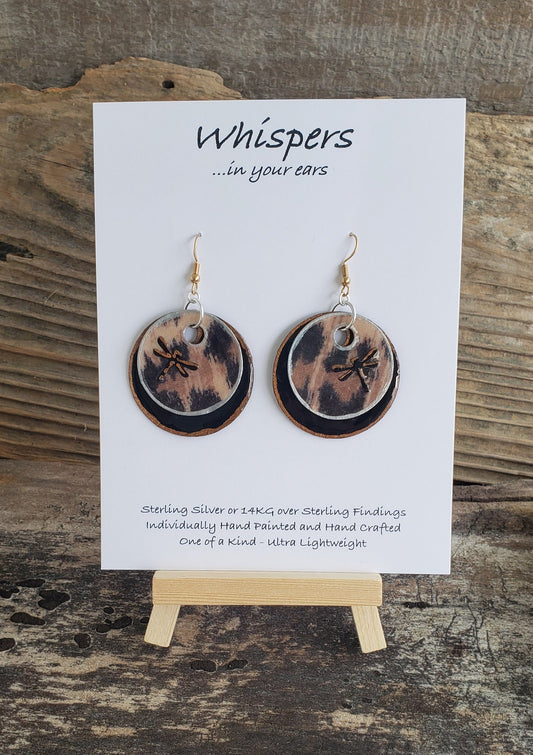 Hand painted ultra lightweight paper earrings. 3D Dragonfly accented cheetah print. Double layer gold and silver painted edge accents.  Back is painted black.  Circular in shape. Sterling Silver and 14kg over silver findings.  Hangs 1 1/2" in Length