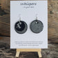 Hand crafted hand painted ultra lightweight paper earrings.  Glossy black with metal 3-D Dragonfly accent. Iridescent pewter textured double Layer Circular in shape. Sterling silver findings. Hangs 1 3/4" in Length